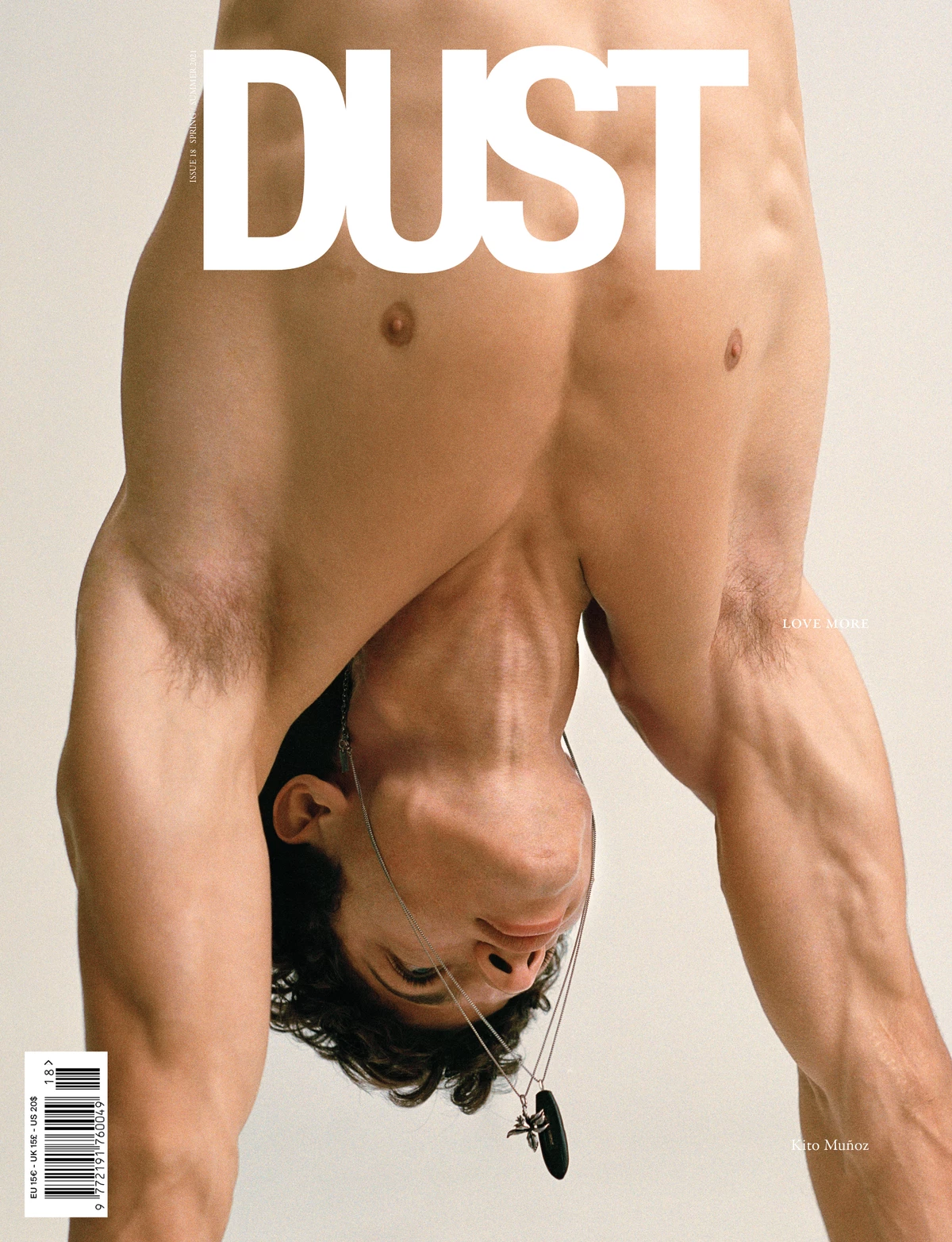 Magazine cover featuring a color photograph of a shirtless male figure inverted upside-down against a neutral beige background.